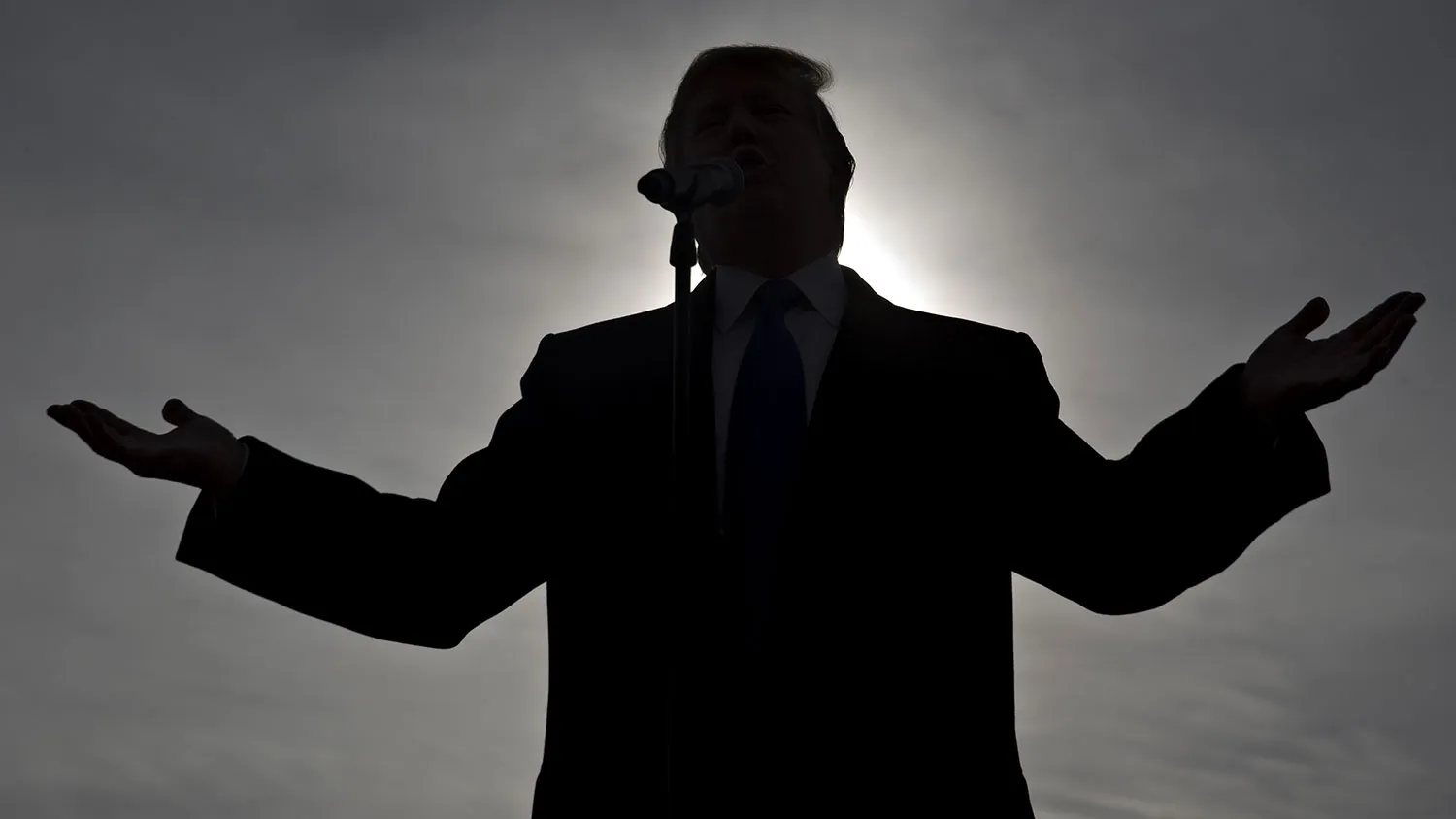 The silhouette of Donald Trump is seen as he speaks during a campaign rally at Dubuque Regional Airport in Dubuque, Iowa, on Jan. 30, 2016.
