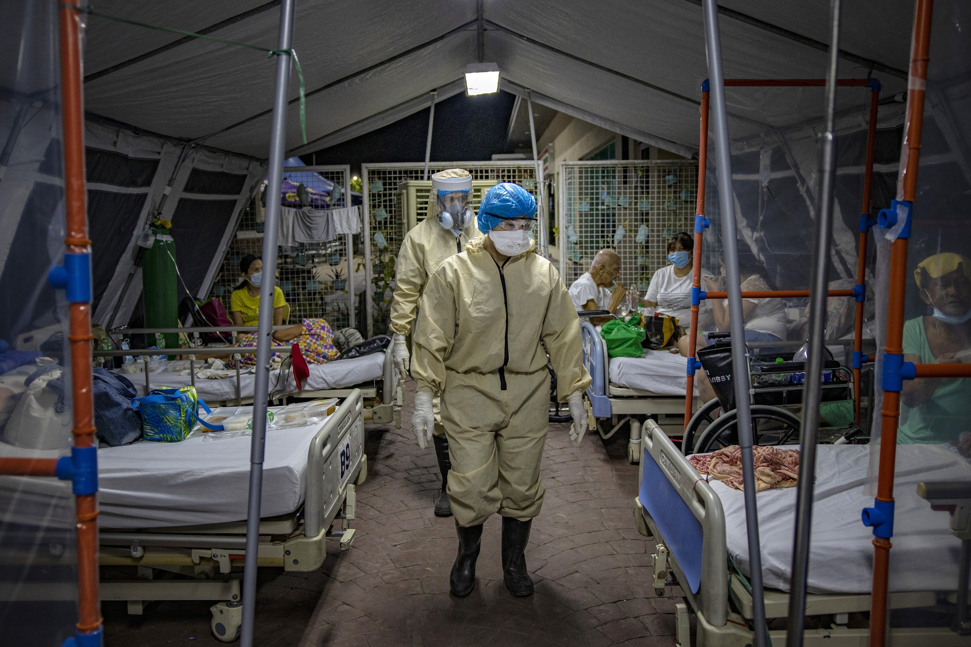 Medical personnel wearing protective clothing work to treat patients inside a tent at a&nbsp;Covid-19 isolation facility, in Quezon city, Metro Manila, Philippines, on May 1.