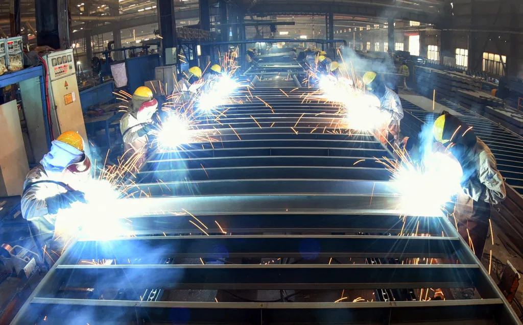 Workers weld containers at a factory in Lianyungang,&nbsp;Jiangsu province.