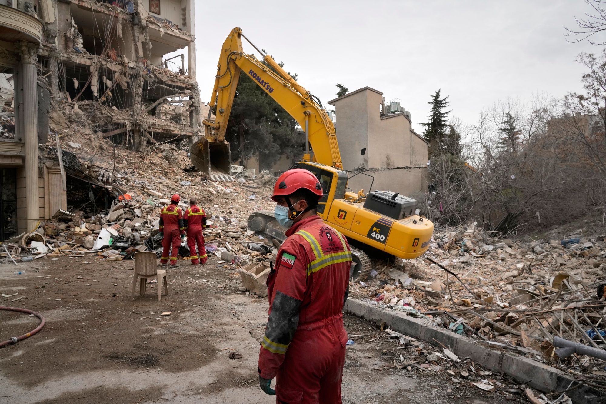 Iranian Red Crescent emergency workers clear rubble from a destroyed building in Tehran on March 23.