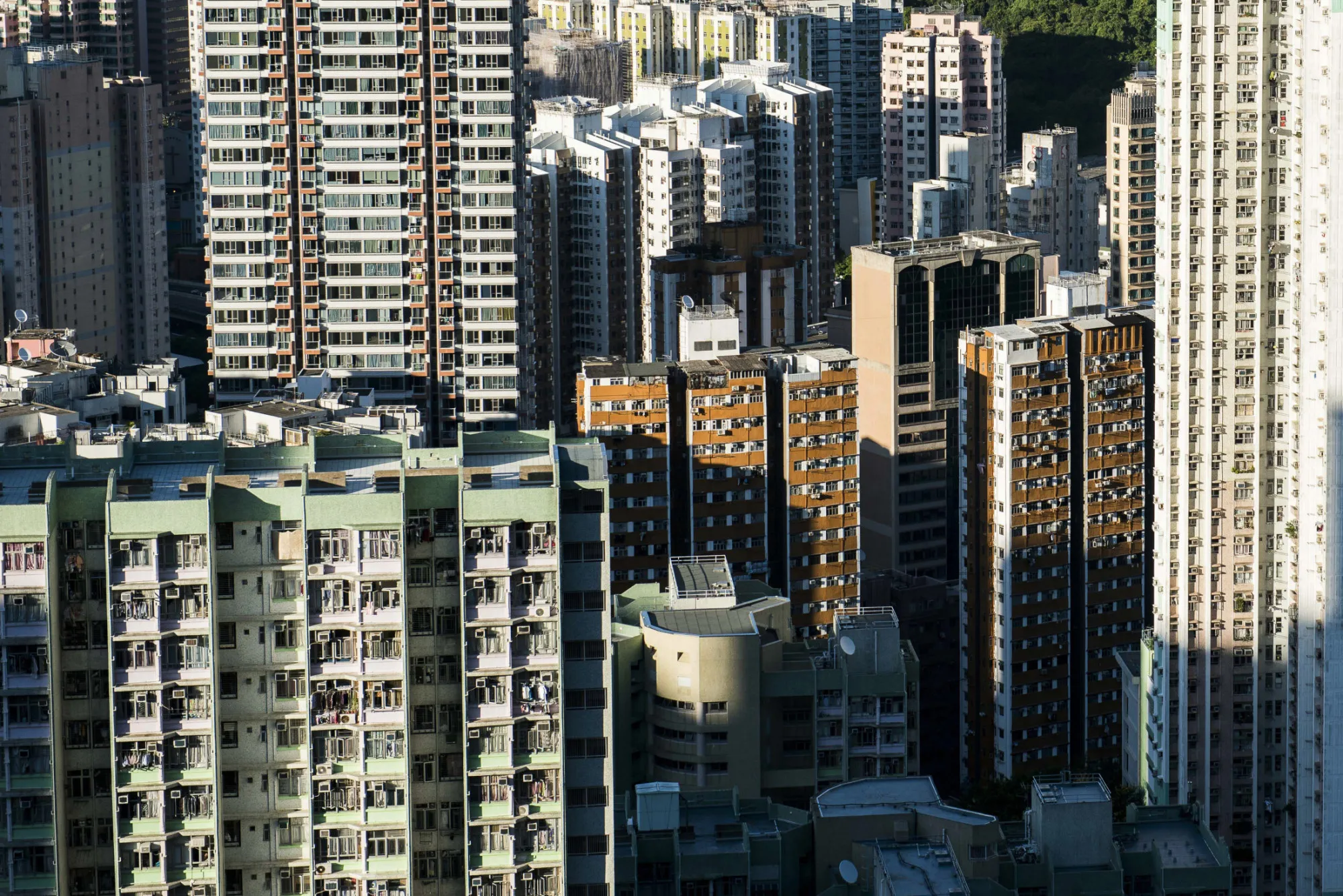 Residential and commercial buildings stand in the Shau Kei Wan district of Hong Kong, China, on Friday, June 19, 2015. Hong Kong is scheduled to release consumer price index (CPI) figures today.
