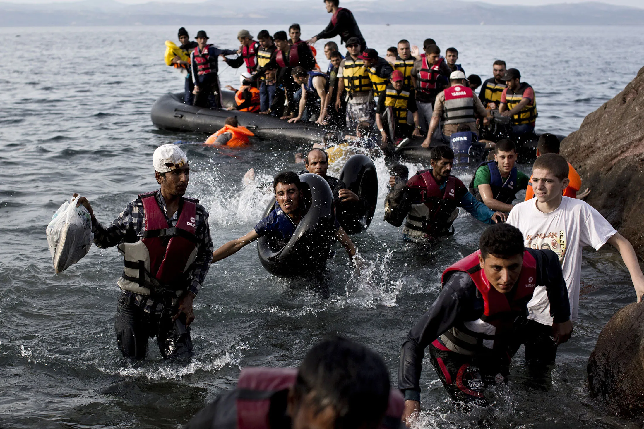 Refugees arrive on Greek shores after crossing the Aegean Sea.
