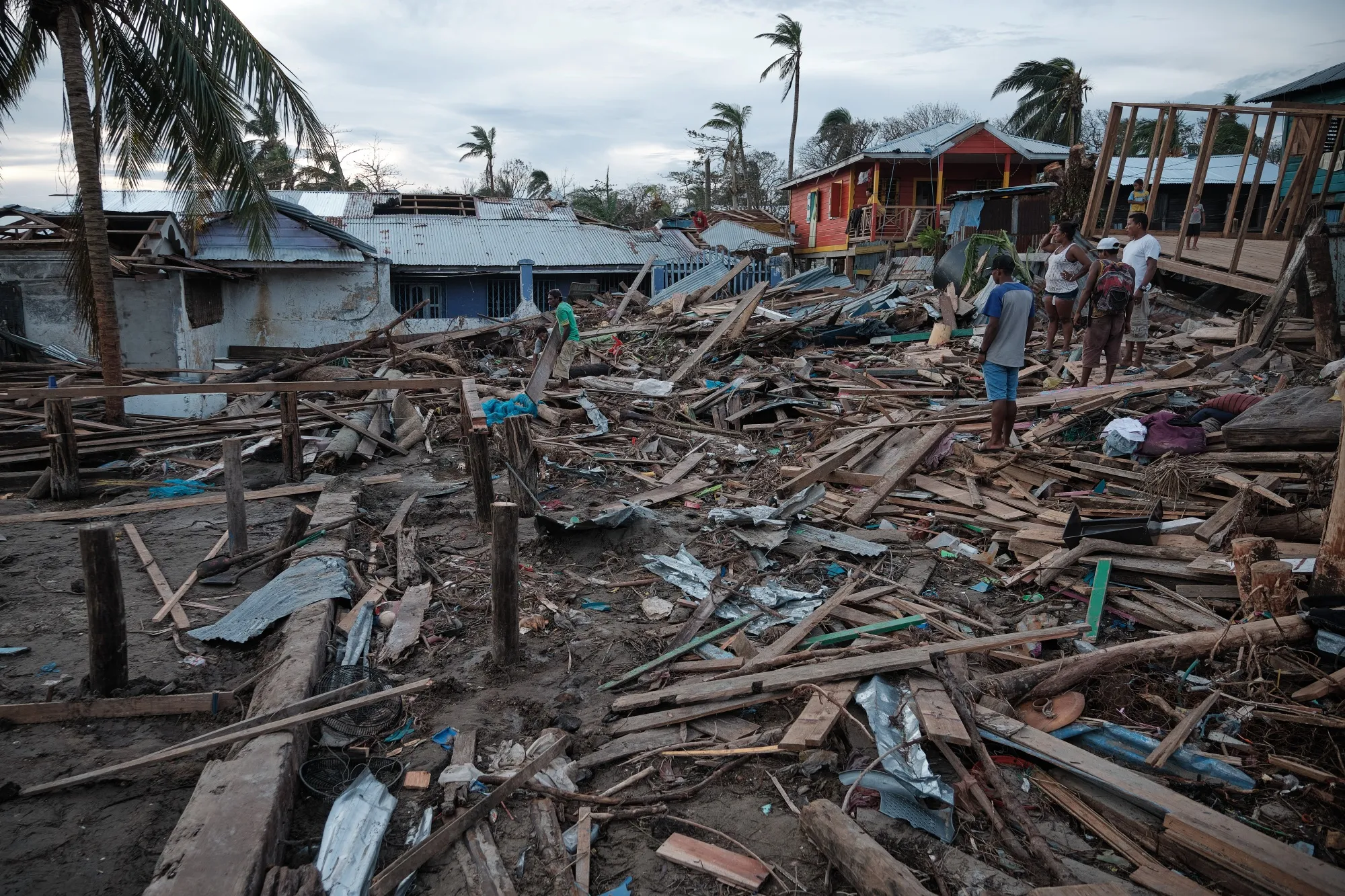 Residents inspect destroyed houses in the coastal neighborhood of El Muelle after Hurricane Iota made landfall in Bilwi, Nicaragua.