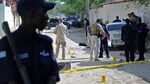 Security officers investigate the scene of a car bomb which killed Somali journalist Hindiya Hajji Mohamud in Mogadishu on Dec. 3.

