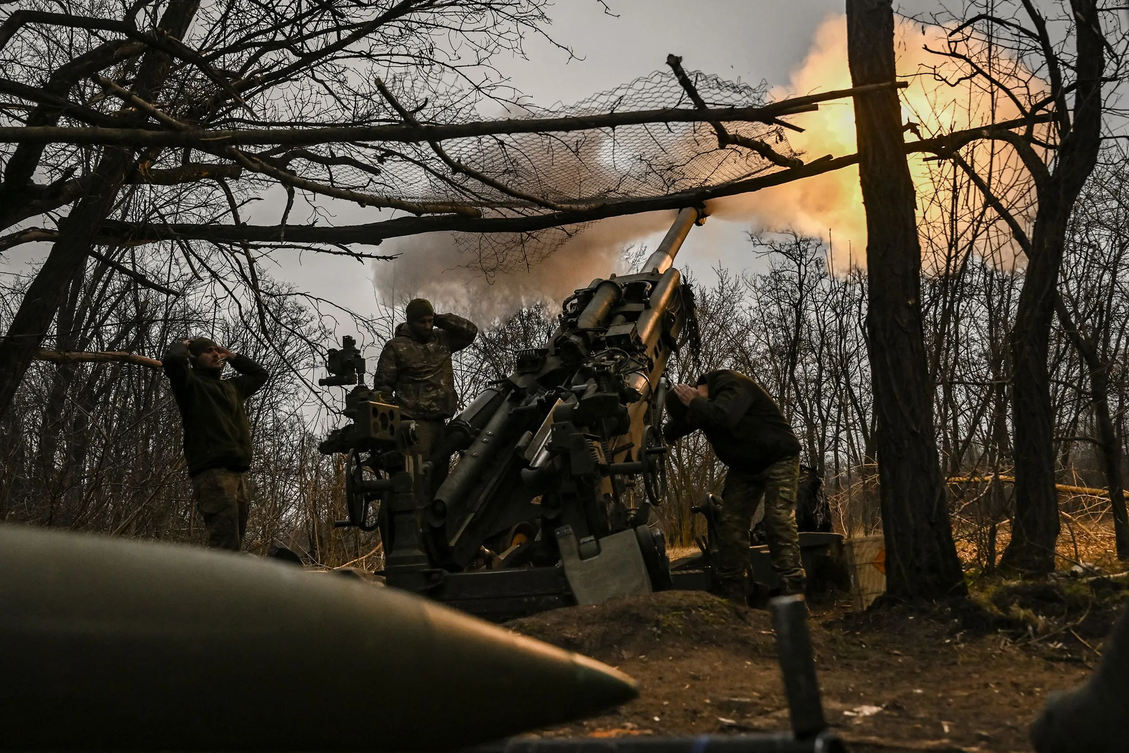 Ukrainian servicemen fire a M777 howitzer at Russian positions near Bakhmut, eastern Ukraine, on March 17.