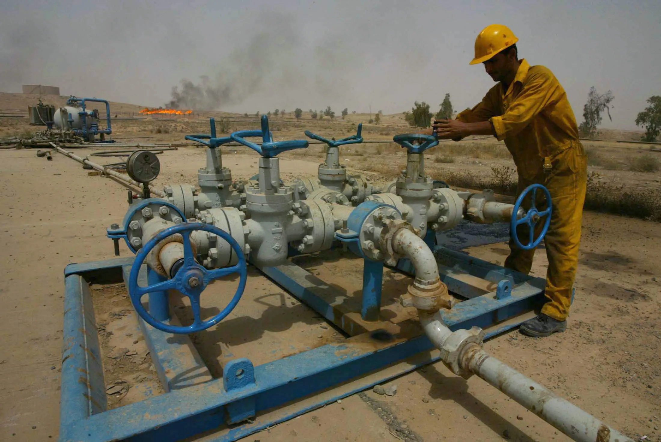 An Iraqi worker checks the valves at the Kirkuk oil field in Iraq.
