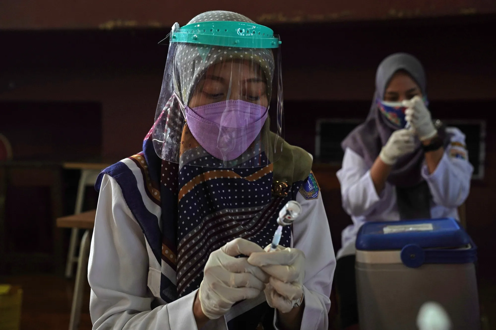 Health workers at a vaccination center in Jakarta, Indonesia.