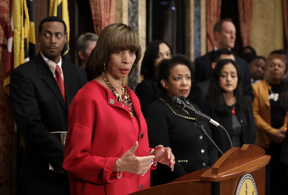 In January, Baltimore Mayor Catherine Pugh announced the city police department's commitment to reforming its practices under a DOJ consent decree. Standing behind Pugh is Attorney General Loretta Lynch, center right. 