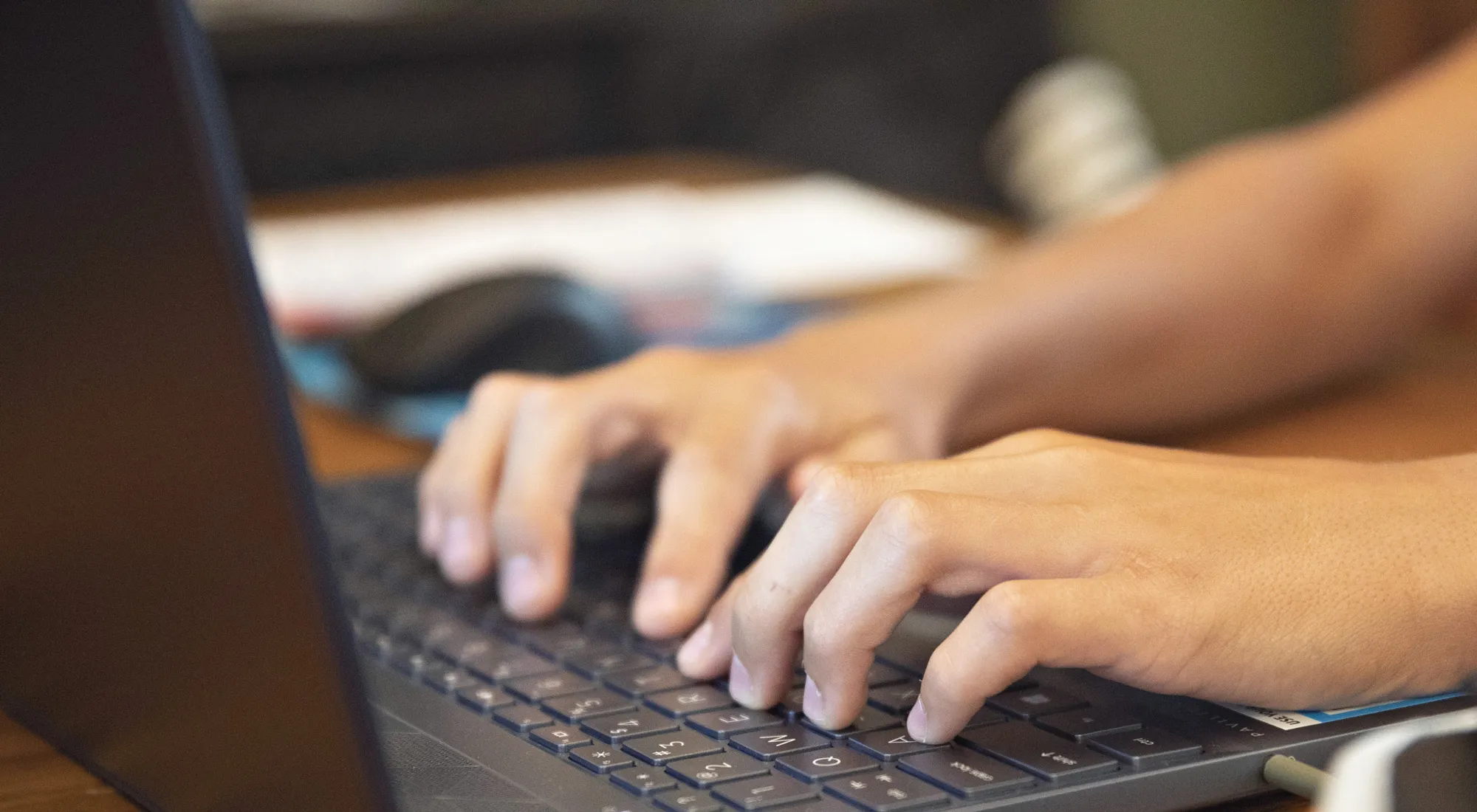 A high school student works on an assignment on a laptop computer on Wednesday, Aug. 19, 2020.&nbsp;