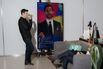 Yusupov (left) watches Rogowsky’s broadcast in Intermedia’s SoHo office.