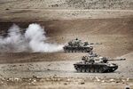 Turkish tanks roll to take positions along the Turkey-Syria border near Suruc, Turkey on Sept. 29
