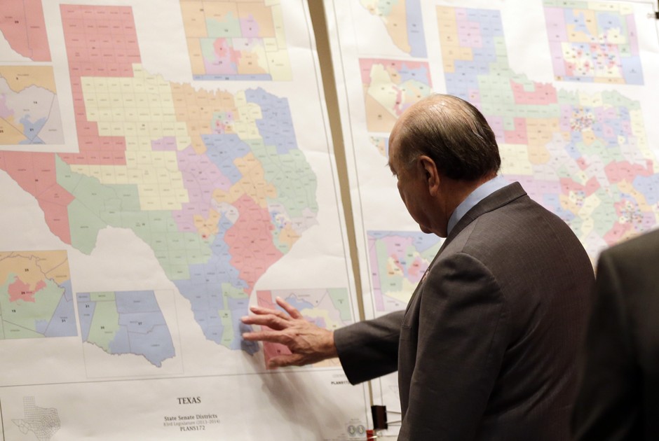 Texas state Sen. Juan &quot;Chuy&quot; Hinojosa looks at maps on display prior to a Senate Redistricting committee hearing, in Austin, Texas.