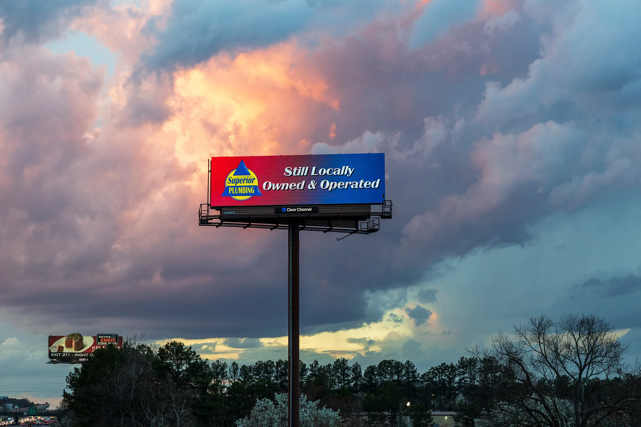 A billboard for Superior Plumbing touting its locally owned credentials.