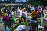 Shoppers browse vegetables at a market in Colombo, Sri Lanka