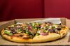 A pizza sits on a table in this arranged photograph inside a Pizza Hut store, operated by Yum! Brands Inc., in the Soweto district of Johannesburg, South Africa, on Saturday, Feb. 14, 2015. International restaurant chains and other retailers are increasing their presence in Africa, which is home to the world's youngest and fastest-growing population, according to a McKinsey & Co. report in 2010.