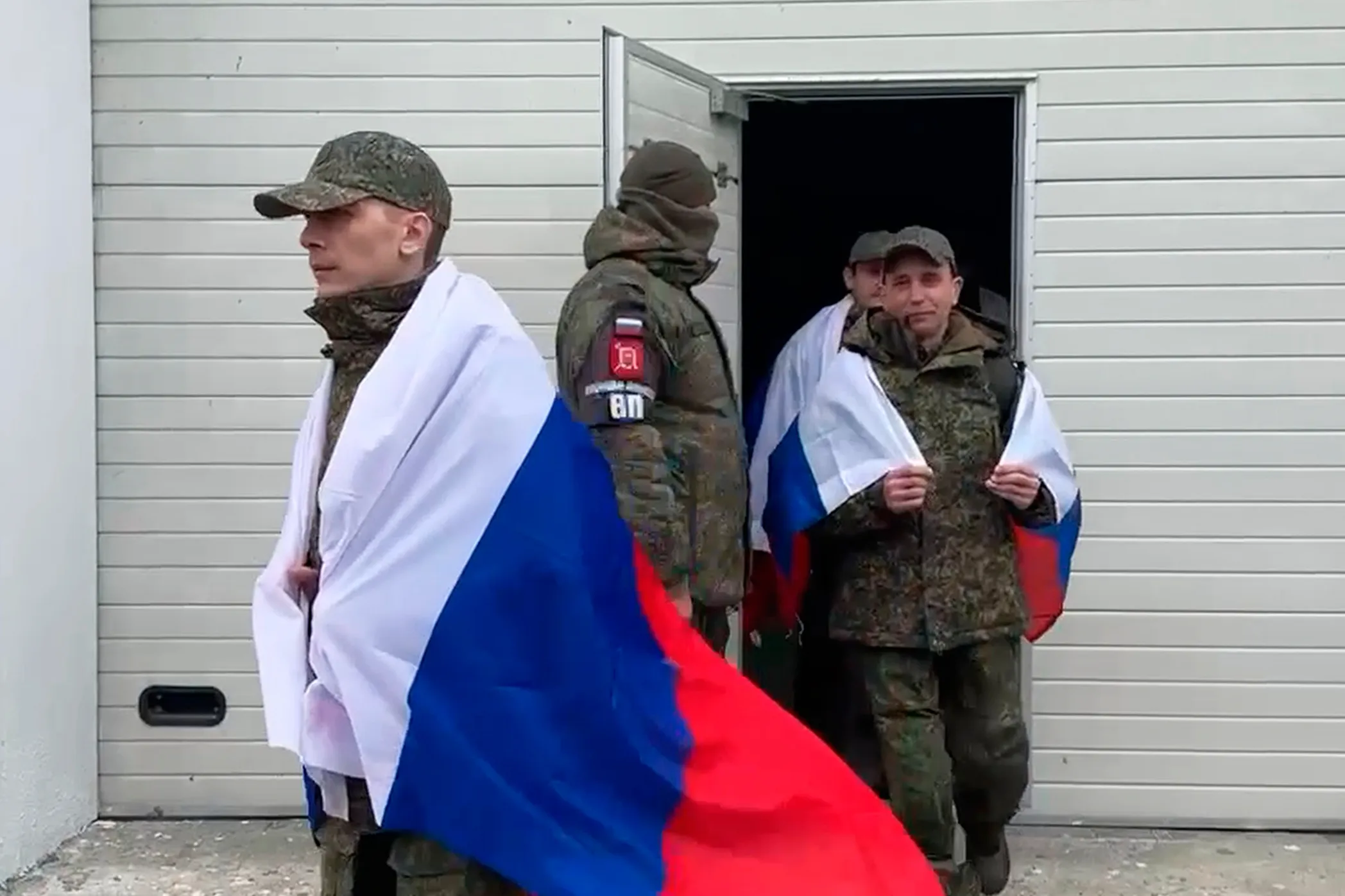 In this image taken from a video provided by Russian Defense Ministry Press Service, Russian servicemen arrive&nbsp;in Belarus after returning from captivity during a POW exchange, on April 11.