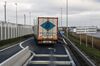 A haulage truck crosses a 'Welcome to France' sign on an access road near the Eurotunal terminal in Calais, France.