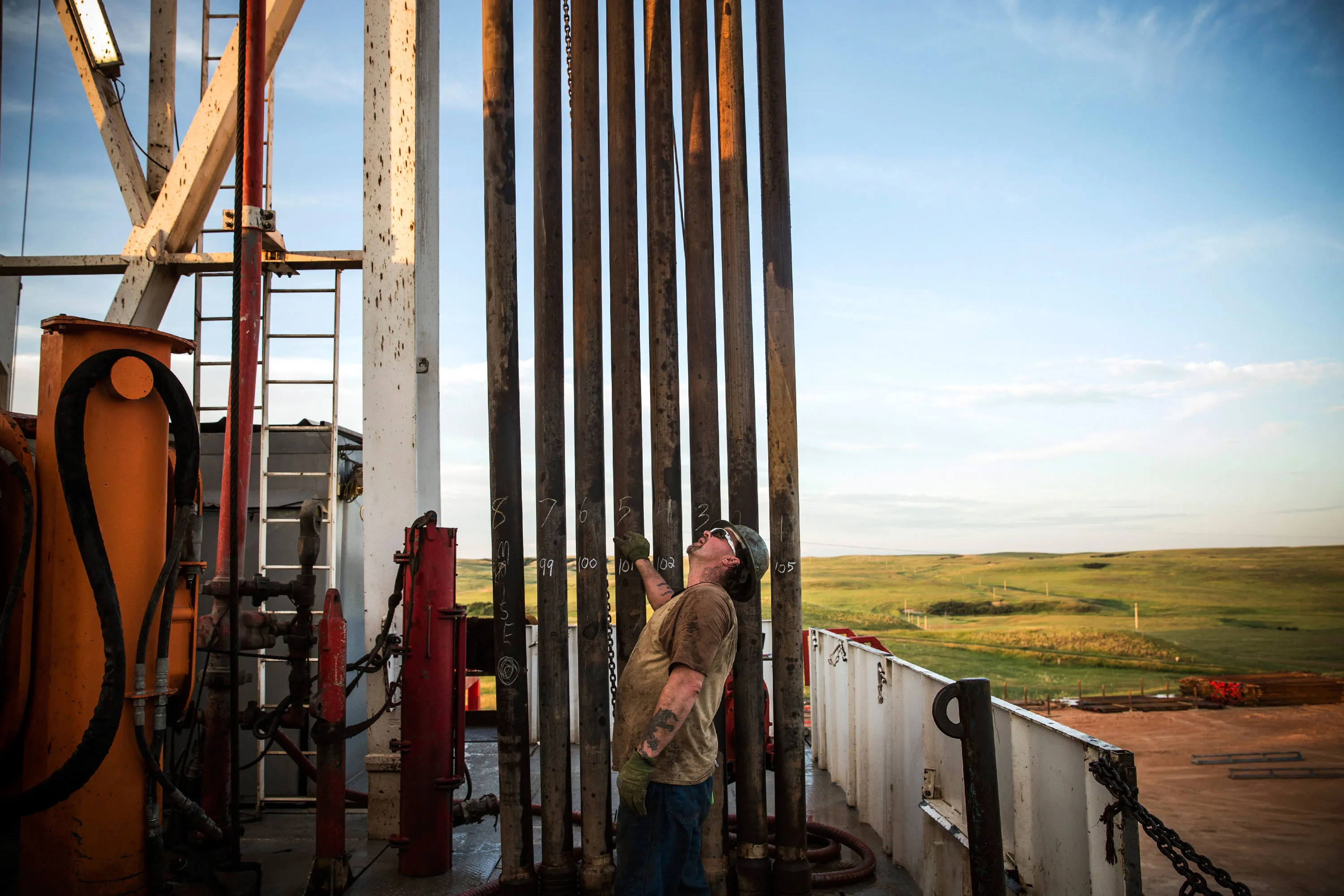 A floor hand waits to line up pipe while drilling for oil in the Bakken shale formation on July 23, 2013 outside Watford City, North Dakota.

