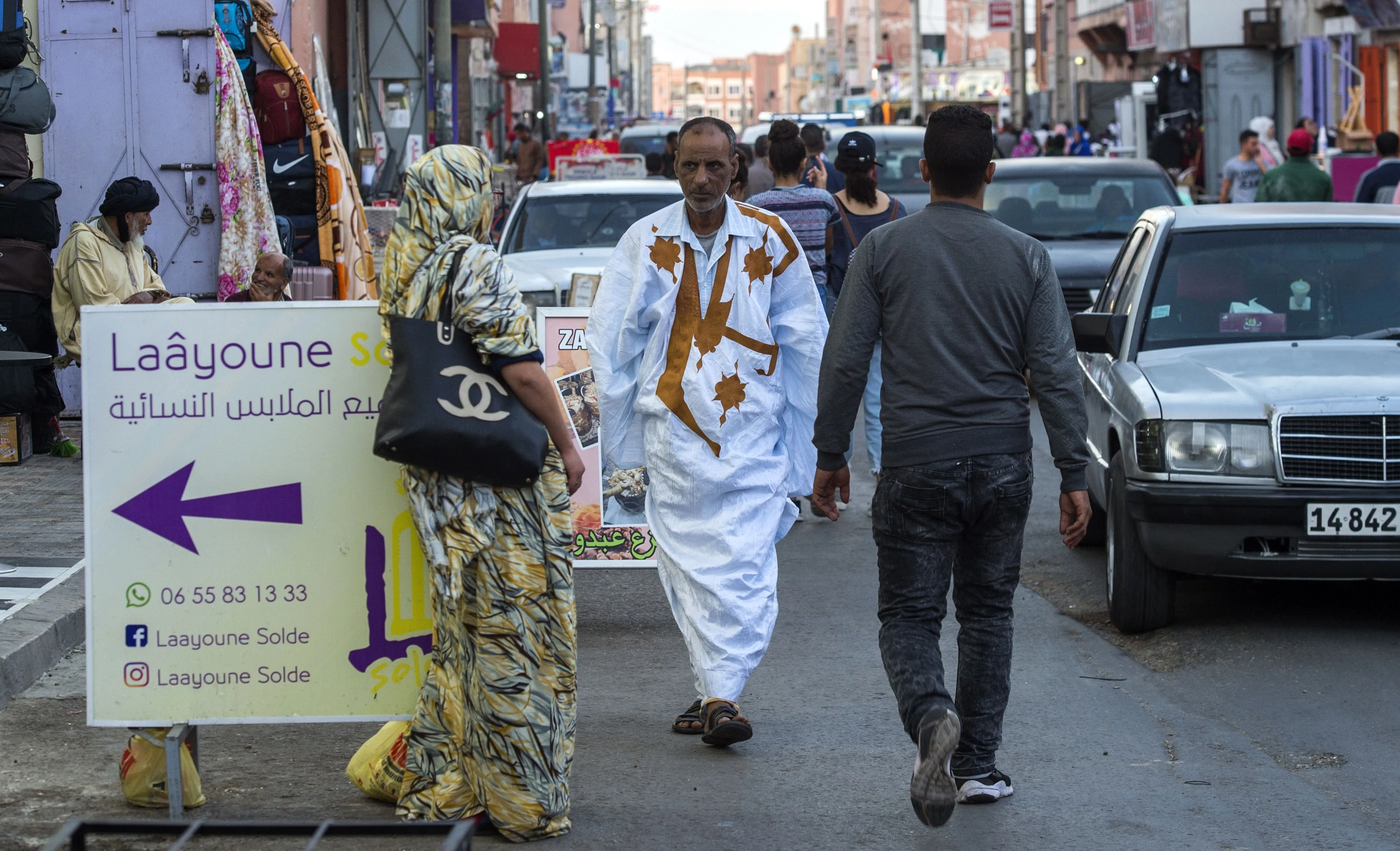 People walk in a market street in the Moroccan-controlled Western Sahara's main city of Laayoune.