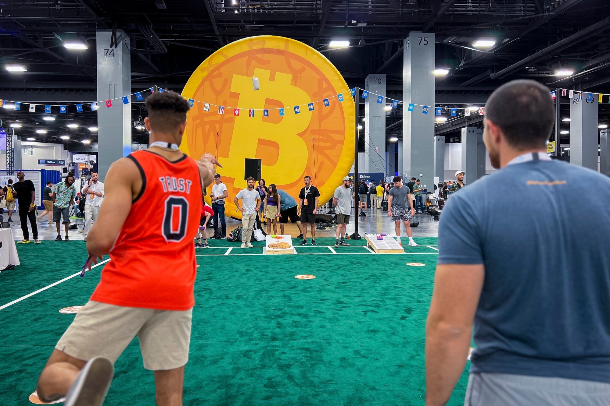 Attendees play cornhole at the expo hall during the Bitcoin 2023 conference in Miami Beach, Florida, on May 20.&nbsp;The American Cornhole League, which began in 2015, has seen its prize money more than double every two years, capitalizing on its growing popularity.