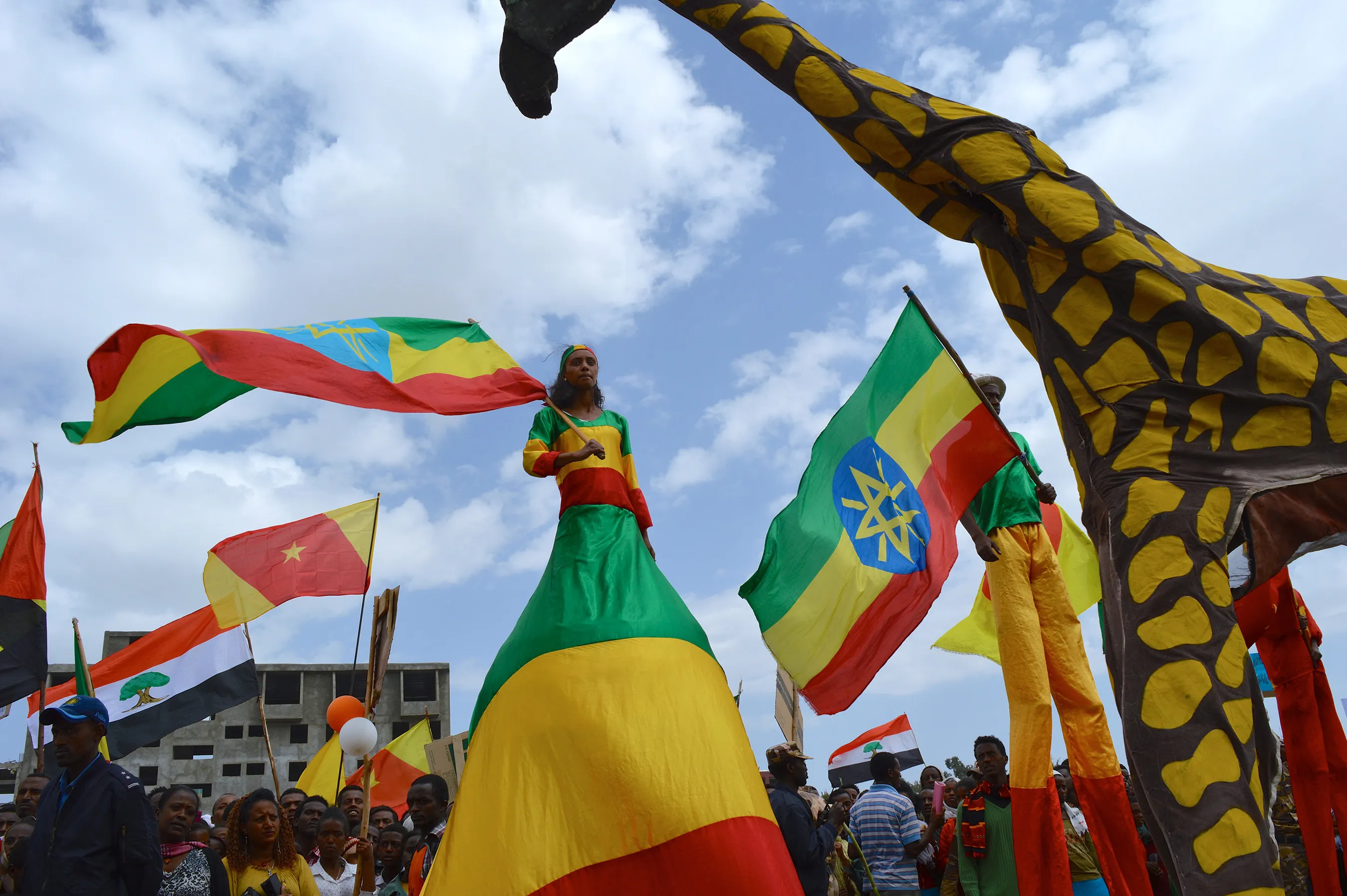 Performers walk on stilts at a rally to celebrate the arrival of the Grand Ethiopian Renaissance Dam (GERD) trophy in Debre Birhan. Photographer: William Davison/Bloomberg
