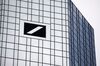 A logo sits on one of the twin towers of the skyscraper headquarters of Deutsche Bank.