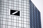 A logo sits on one of the twin towers of the skyscraper headquarters of Deutsche Bank.