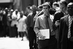 Applicants wait to enter a job fair in New York City