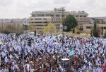 Demonstrators march carrying Israeli national flags during a protest against prime minister Benjamin Netanyahu’s coalition government and proposed judicial changes in Jerusalem, Israel, on March 27.