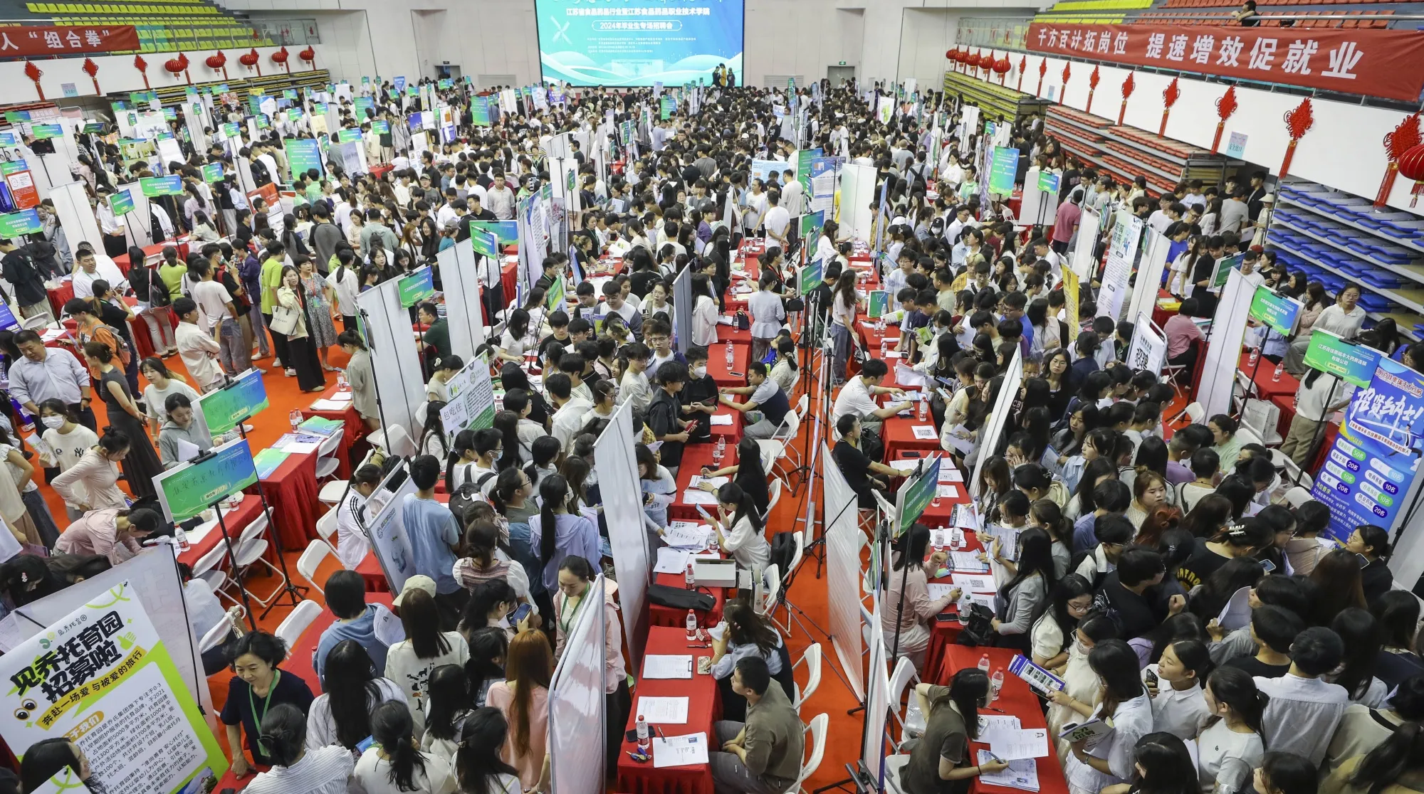 College students at a campus job fair in Huaian city, Jiangsu province, in June.