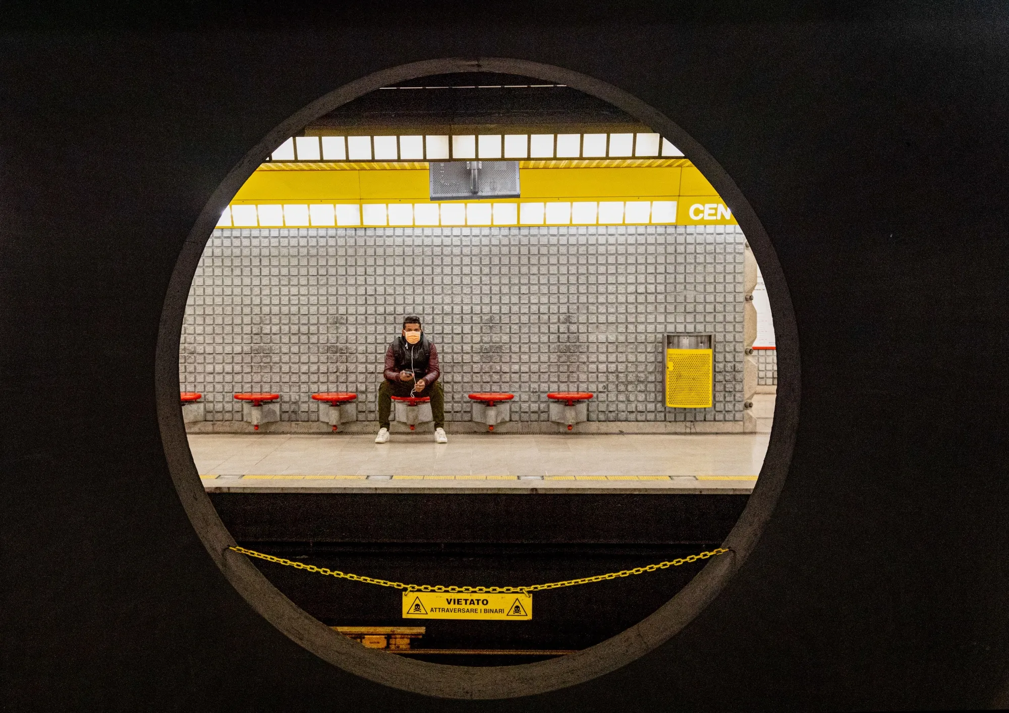 A commuter&nbsp;wearing a protective face mask&nbsp;waits on the platform for a subway train in Milan on March 12.