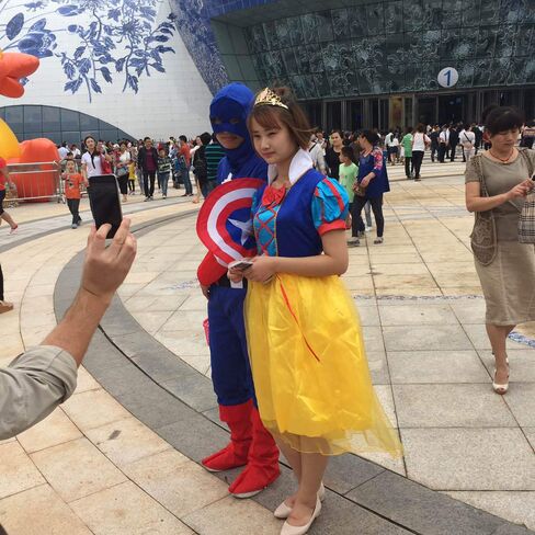 Performers show up at the Wanda City park dressed as Marvel's Captain America and Disney's Snow White.