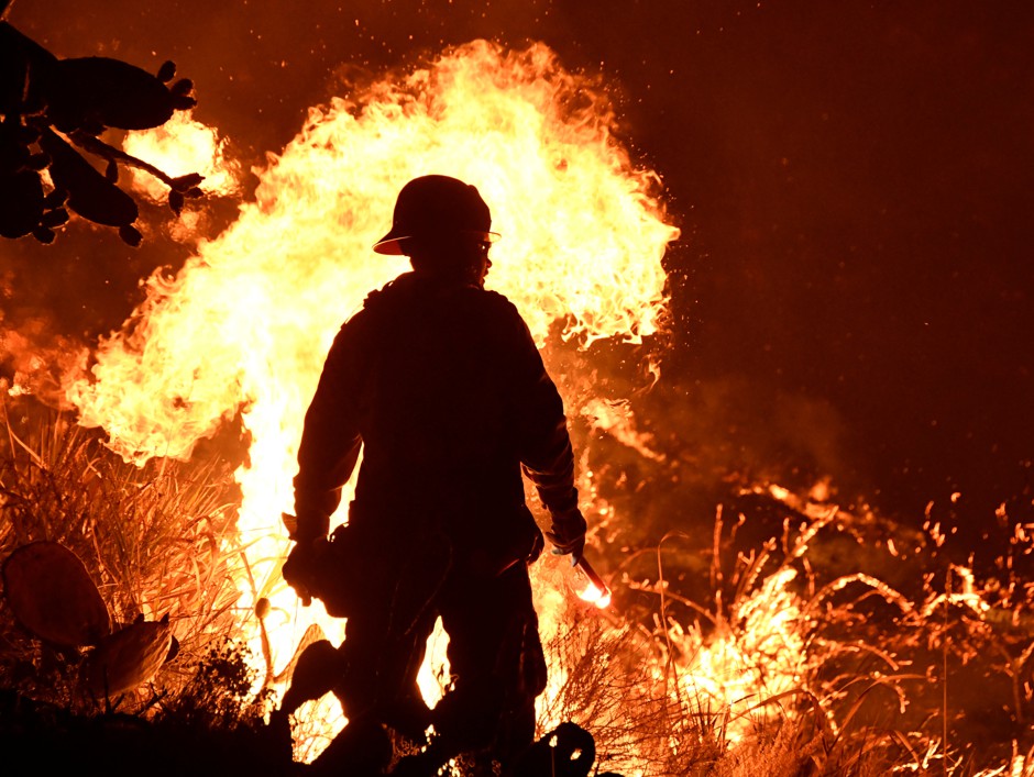 Firefighters battle a brush fire near Ventura, California.