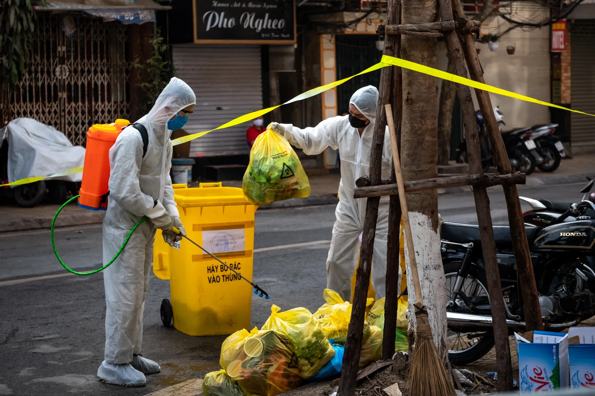 Environment workers disinfect and collect waste from the quarantined area on Truc Bach Street in Hanoi on March 9.