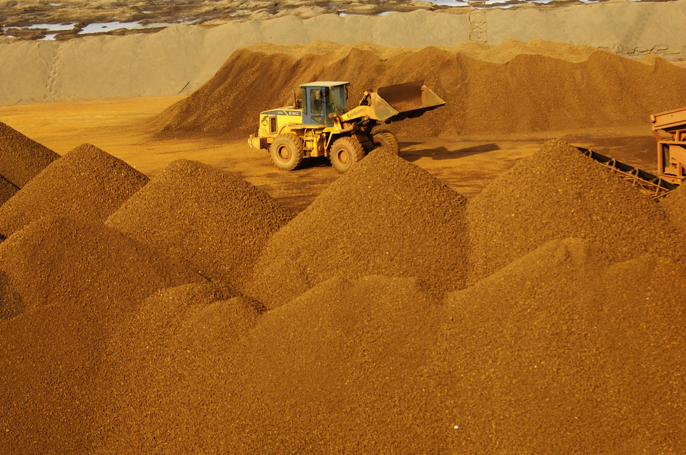 An iron ore stock yard in Tianjin. Aggregate volumes across the nation’s three biggest exchanges have shrunk to the lowest level in six months, a shadow of the fevered trading in March and April when retail investors charged into markets for everything from iron ore to cotton.
