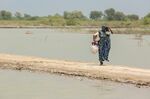 A woman carries a pot to fill drinking water in Umerkot district in Sindh province on Sept. 10. 