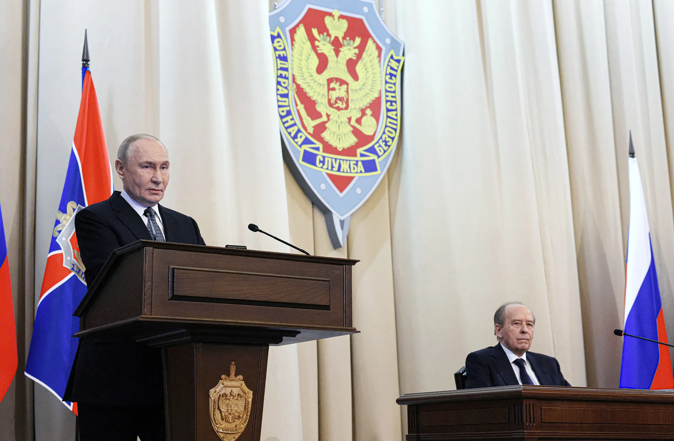 A handout photograph distributed by the Russian state agency Sputnik, of Russian President Vladimir Putin with FSB’s Director Alexander Bortnikov at an FSB meeting in Moscow on Feb. 24.