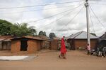 A woman walks under the transmission lines of a Husk Power mini-grid in Rukubi, Nasarawa state, Nigeria.  Source: Husk Power