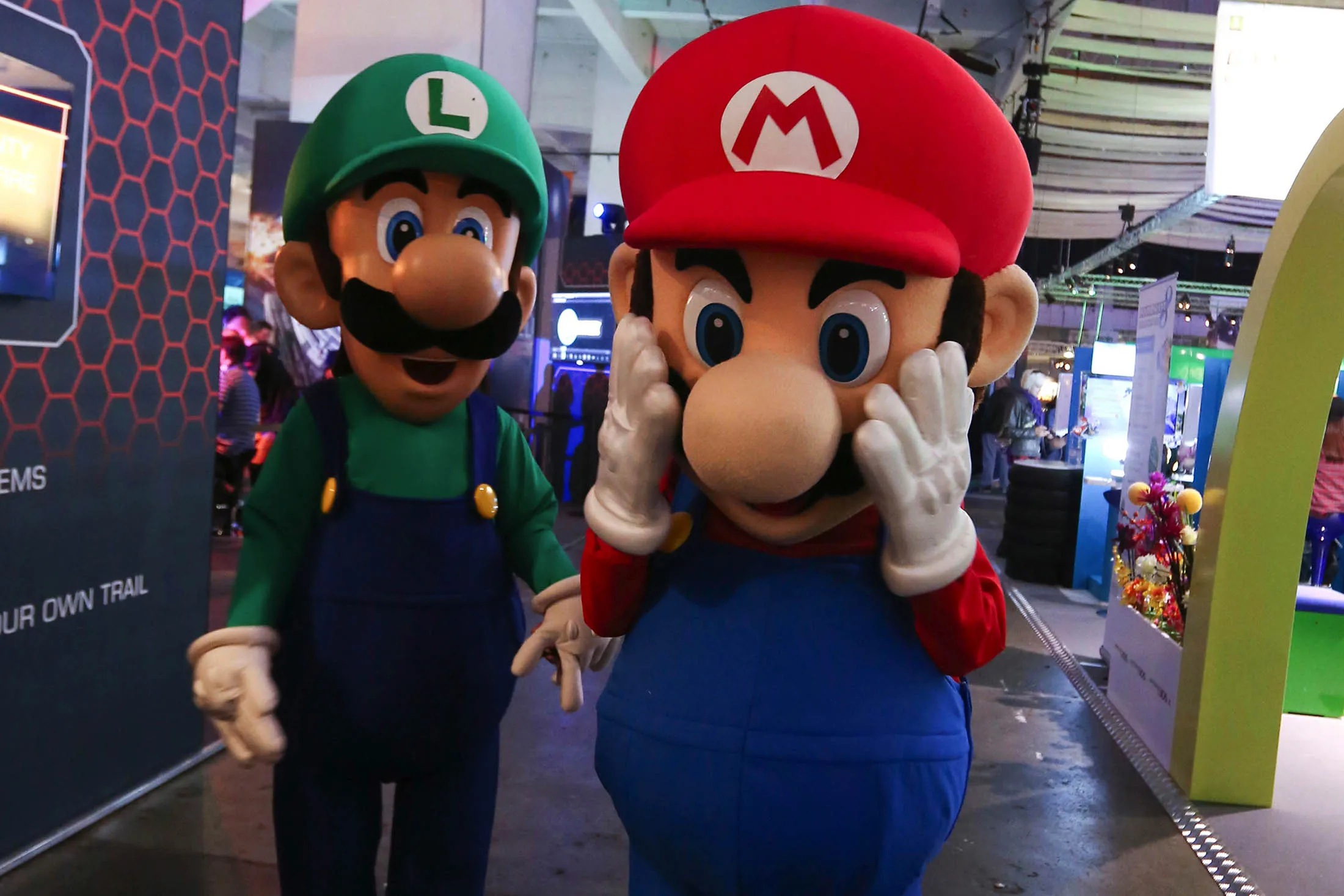 Workers dressed as Nintendo's Mario and Luigi characters.
