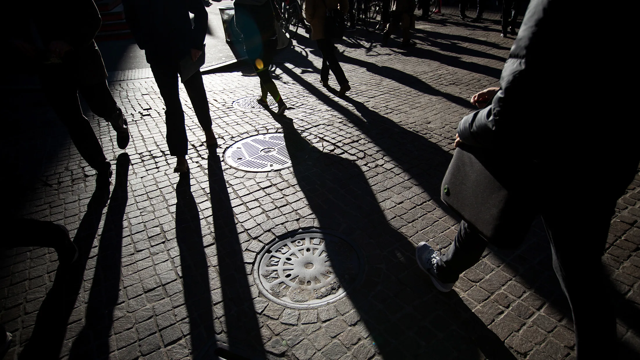 Pedestrians walk along Wall Street near the New York Stock Exchange.
