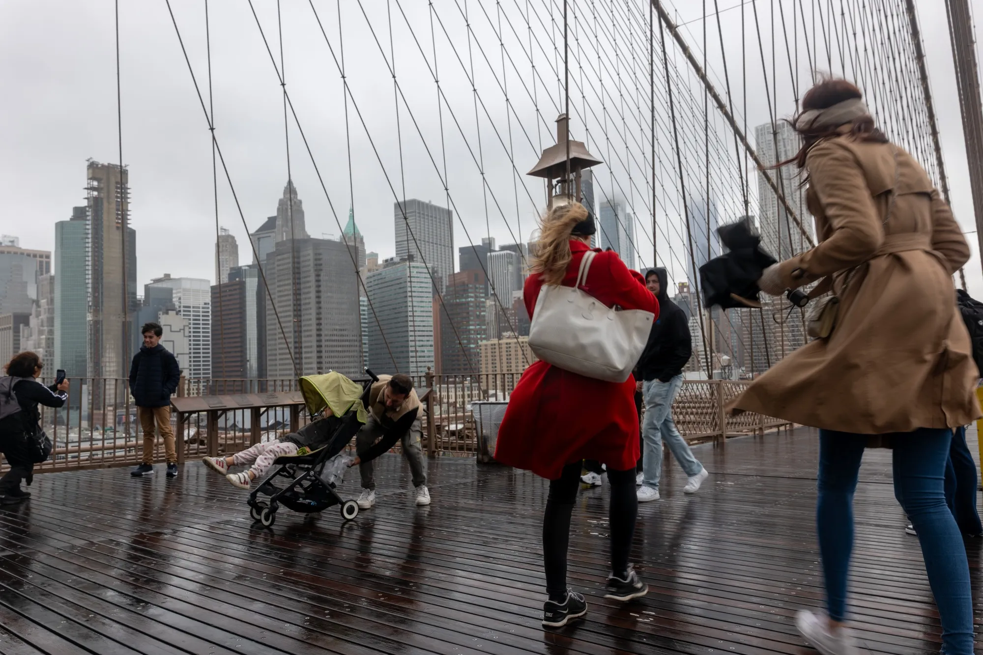 People walk over the Brooklyn Bridge in the rain during&nbsp;a nor’easter storm moving through the East Coast region&nbsp; in New York on Oct. 13.&nbsp;