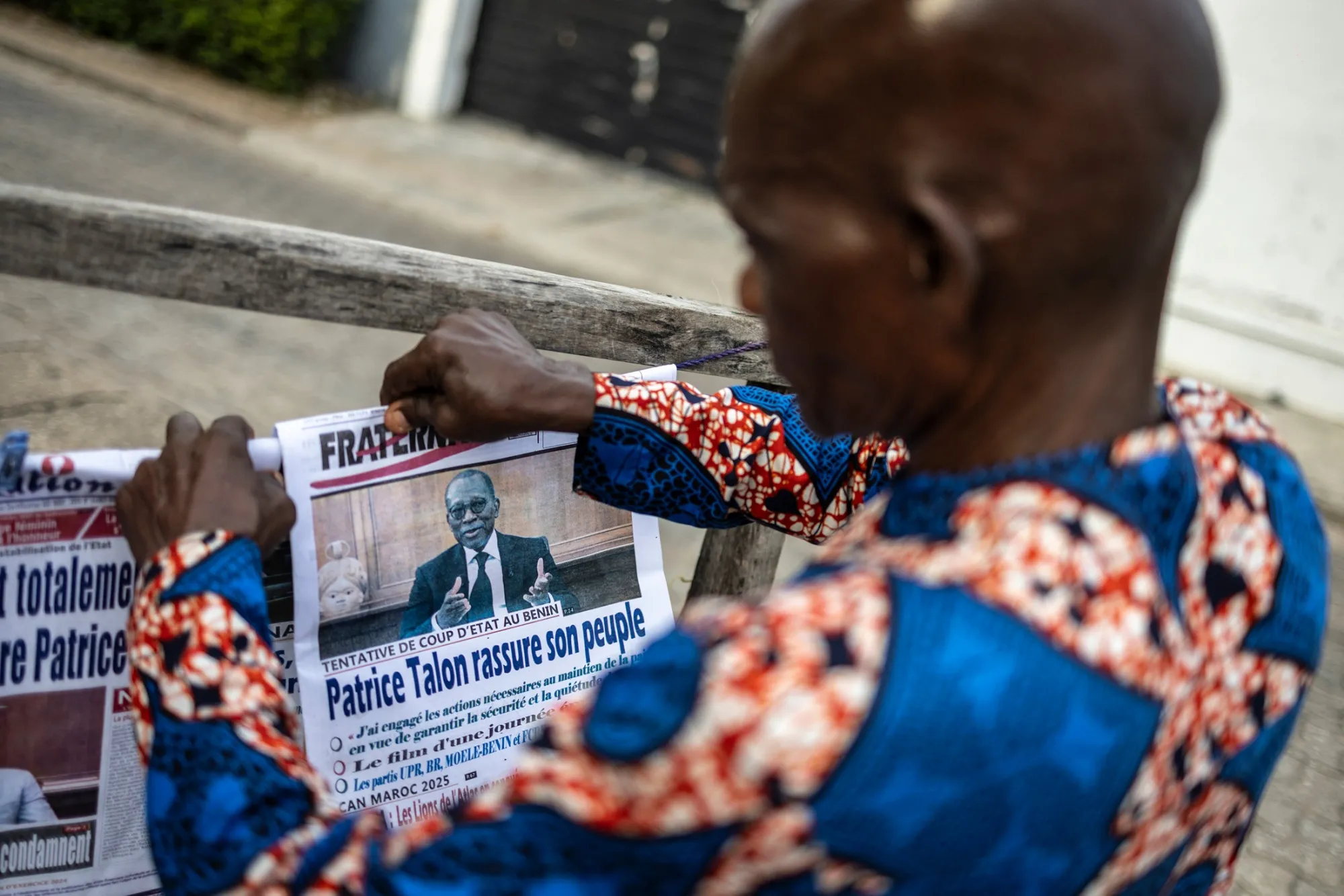 A vendor arranges newspapers featuring the image of President Patrice Talon, at a stall in Cotonou, Benin, on Dec. 8.