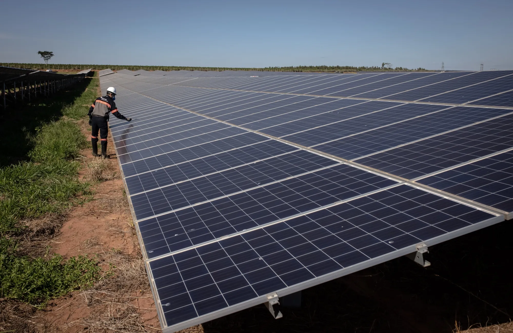A contractor works on photovoltaic modules on a solar farm in Sao Paulo state, Brazil.