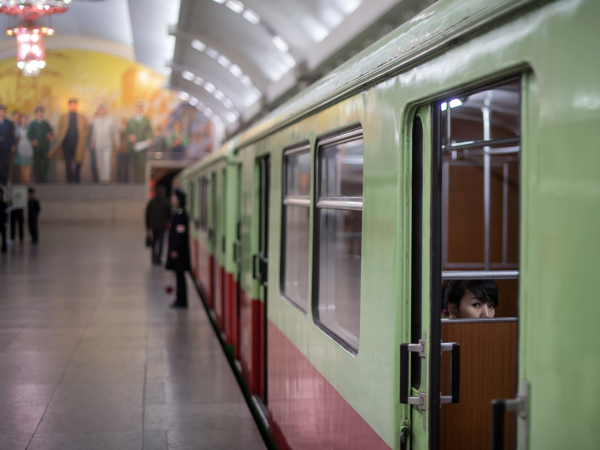 A woman sits aboard a train carriage at a subway station in Pyongyang.