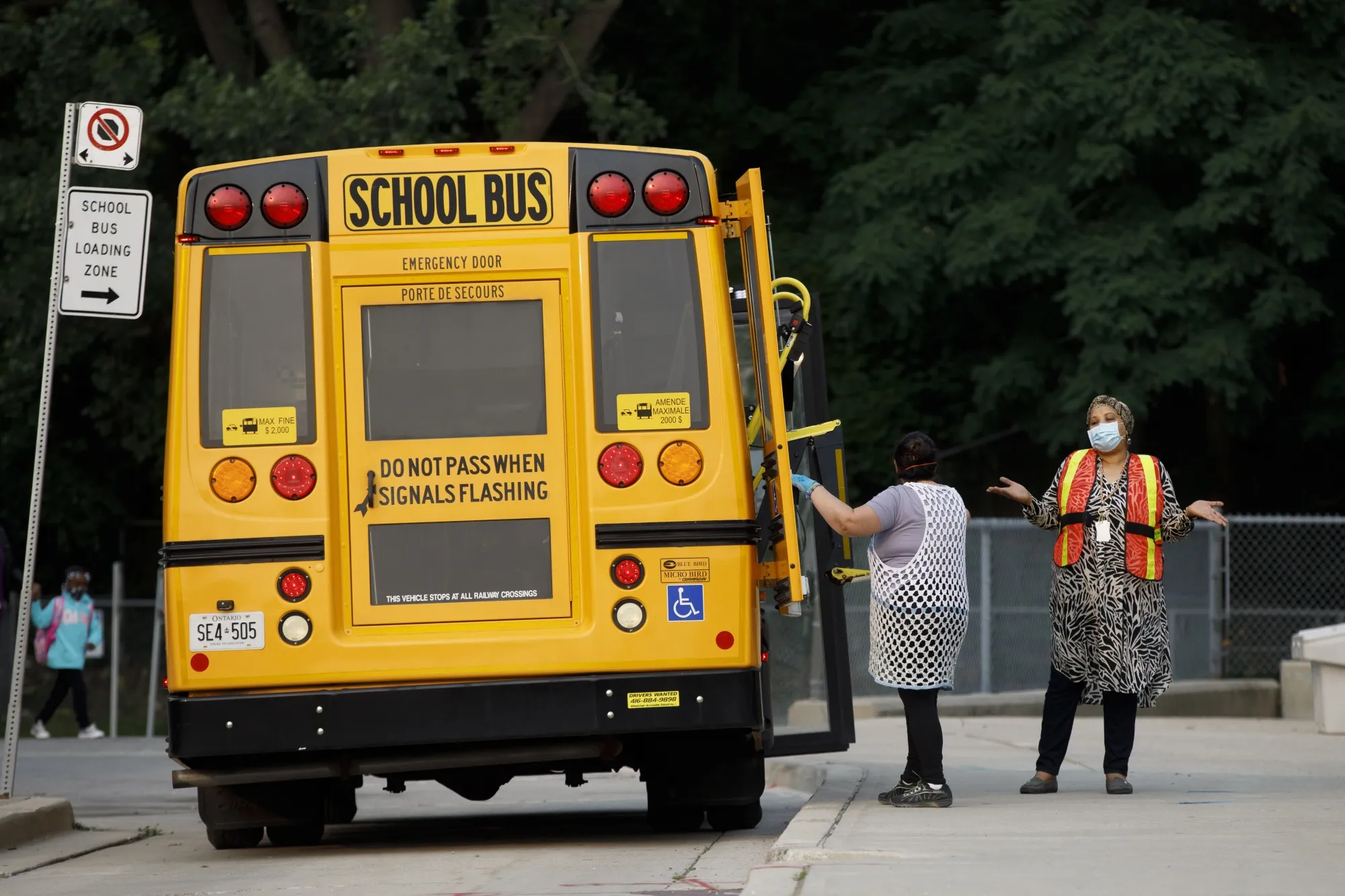 A school bus drops off a student&nbsp;in Toronto.