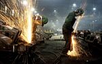 Workers use grinders to smooth down the welded joints at a facility in Columbus, Ohio, U.S..