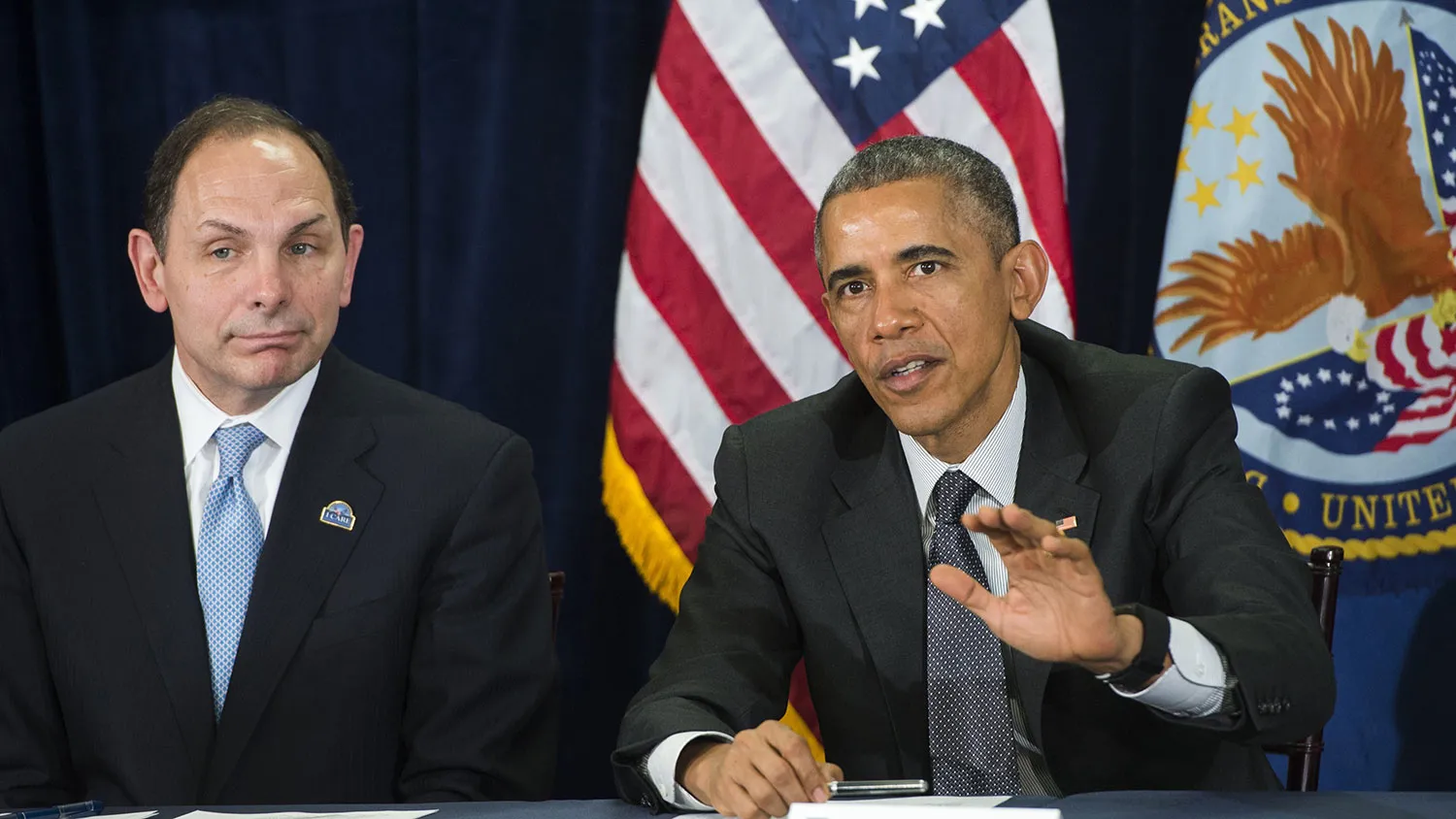 US President Barack Obama speaks alongside Secretary of Veterans Affairs Robert McDonald (L) following a briefing on US military veterans healthcare at the Veterans Affairs (VA) Medical Center in Phoenix, Arizona, March 13, 2015.
