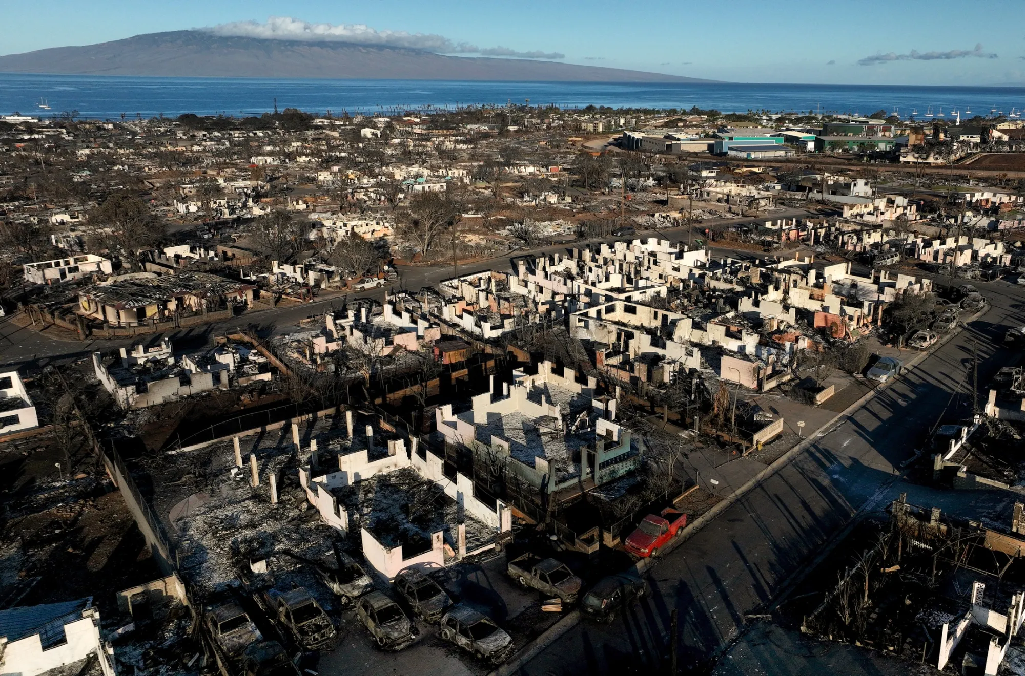 Burned cars and homes in Lahaina, Hawaii.&nbsp;