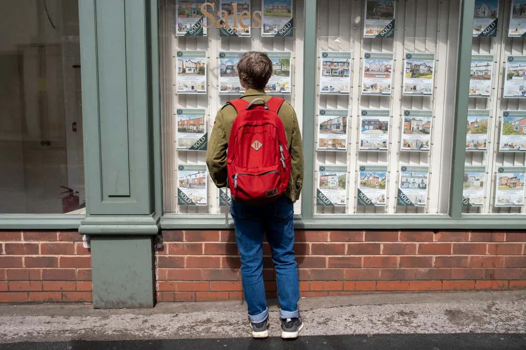 A woman looking in the window of an estate agent in Birmingham.