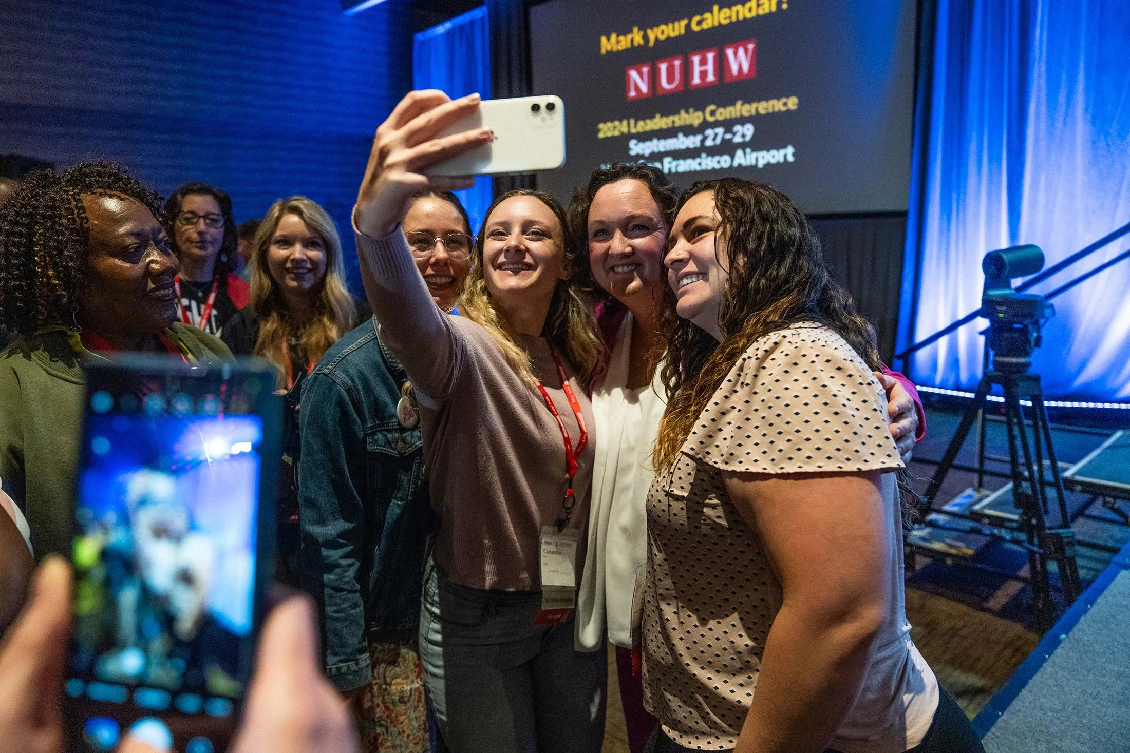 Representative Katie Porter (second from right) poses for a selfie after the National Union of Healthcare Workers Senate Candidate Forum in Los Angeles on Oct. 8, 2023.